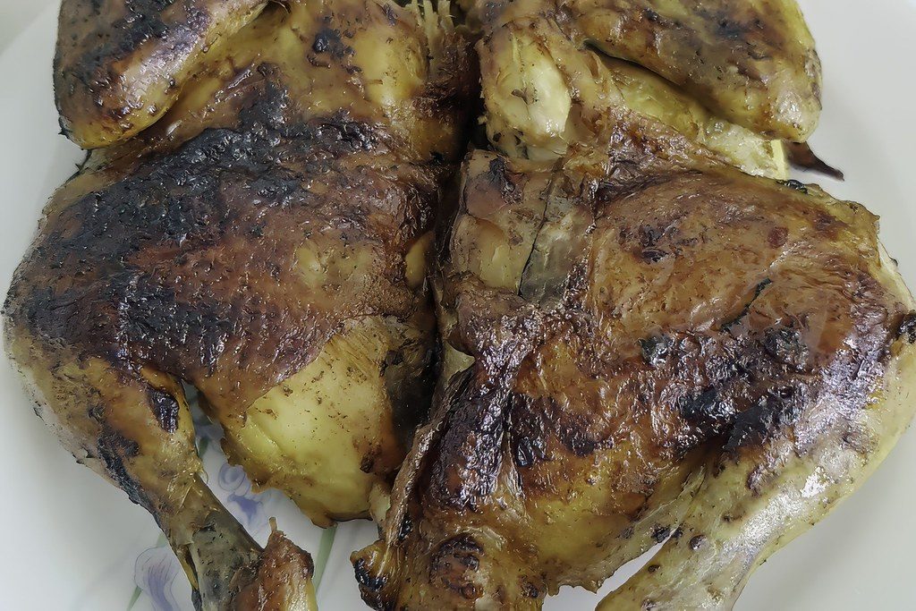Crispy lemon herb chicken thighs in a cast iron pan